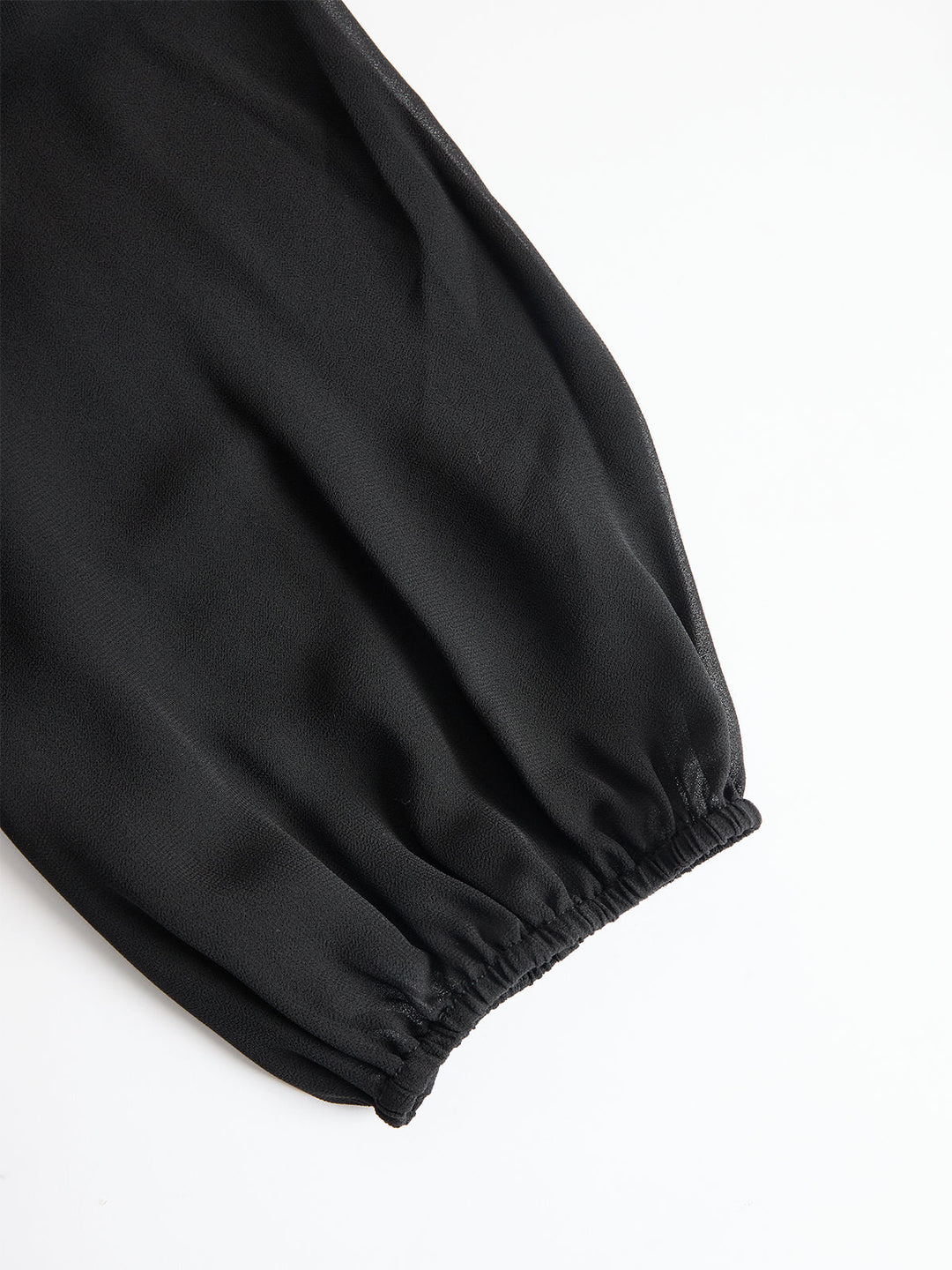 Detail view of banded cuff on puff sleeve