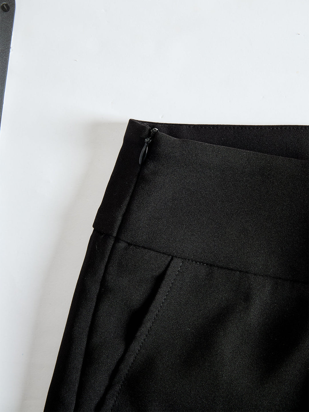Detail view of banded waist with side zip and side pocket