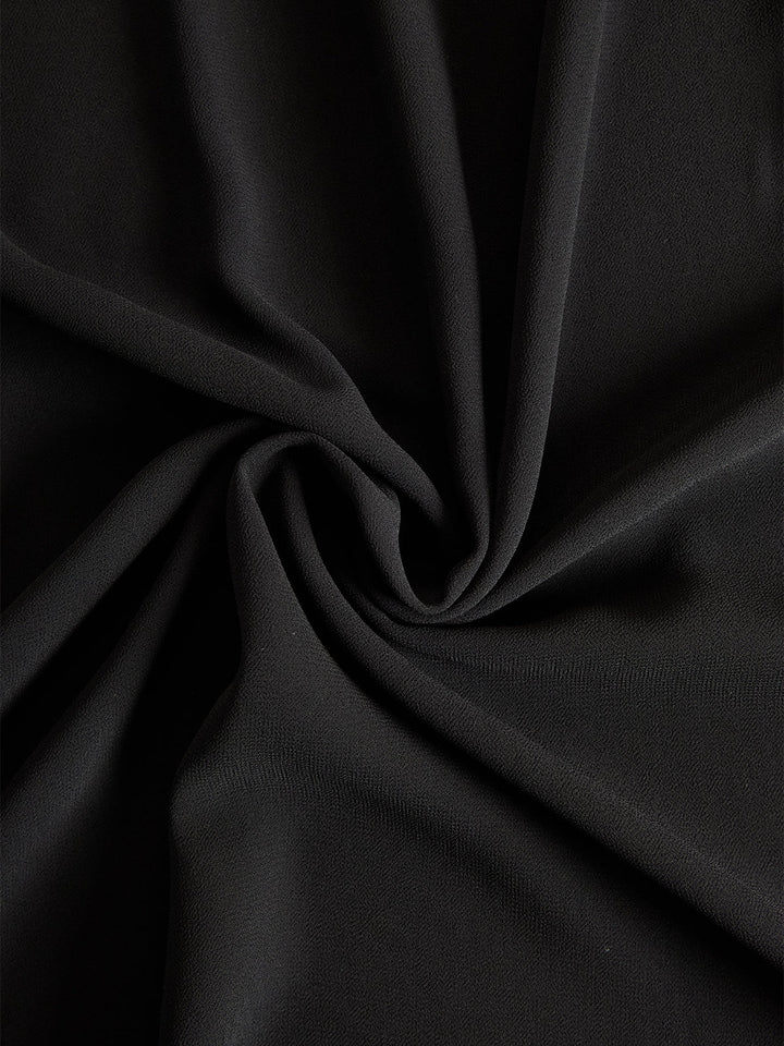 Detail view of the three-piece chiffon and satin set surface