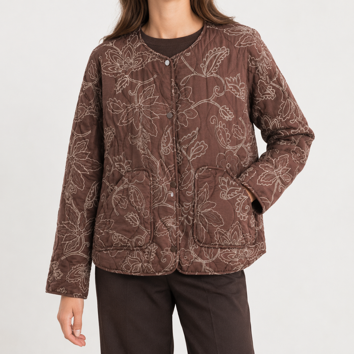 Front view showing round neckline, snap front placket, long sleeves and patch pockets, brown