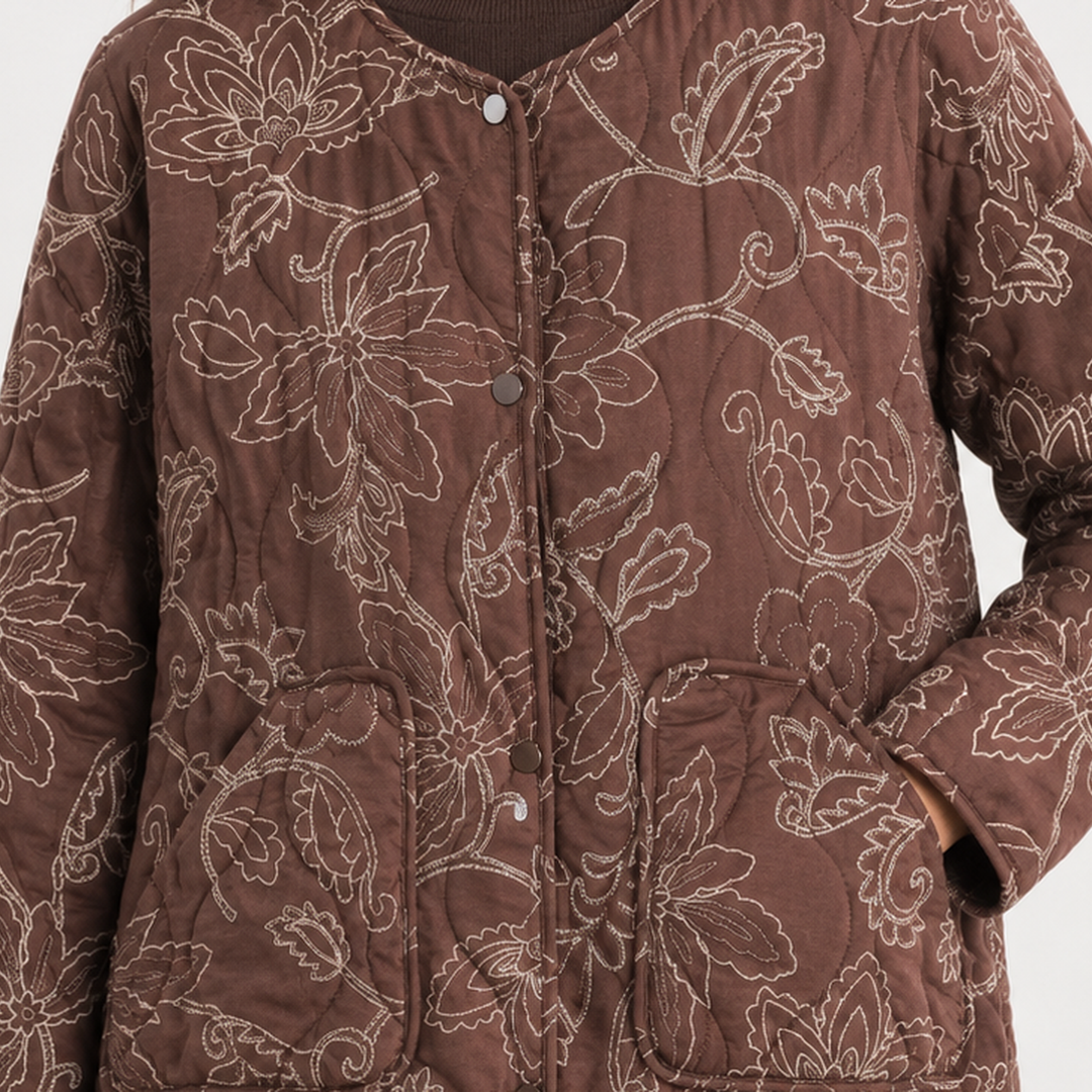 Detail view of snap front placket, floral embroidery and patch pockets