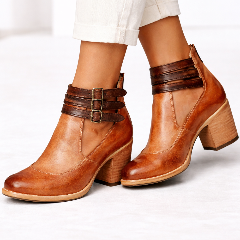 Front view of rounded toe upper with triple ankle straps, buckles and block heel, brown