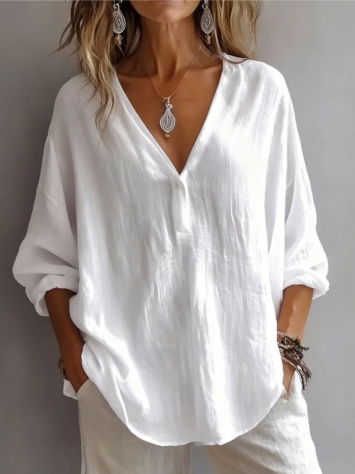 Front view showing deep v-neckline, button placket and curved hem, white