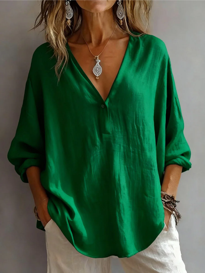 Front view showing deep v-neckline, long sleeves and curved hem, green
