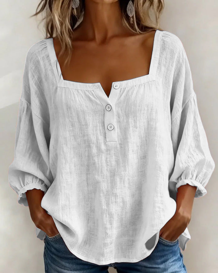 Front view showing square neckline, button placket and three-quarter sleeves, white