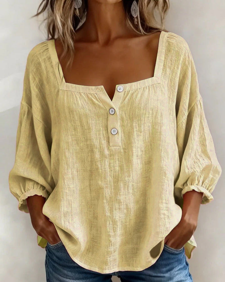 Front view showing square neckline and gathered cuffs, yellow