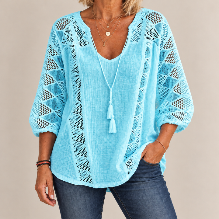 Front view showing crochet sleeve panels and banded cuffs, light blue