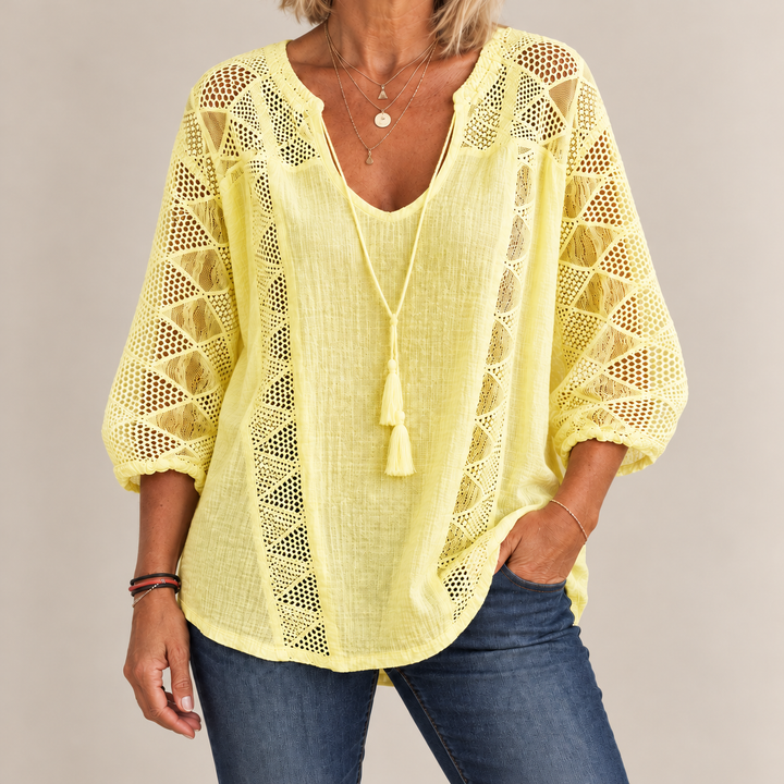 Front view showing crochet sleeve panels and tassel tie, yellow