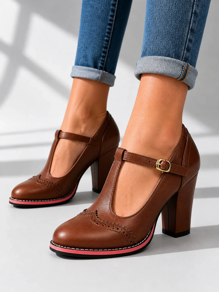 Side view showing t-bar strap, buckle, brogue toe and block heel, brown