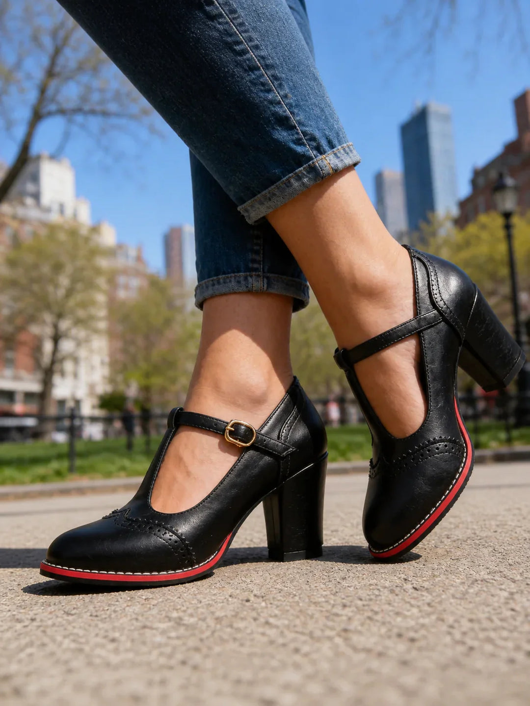 Side view showing t-bar strap, buckle, brogue detailing and block heel