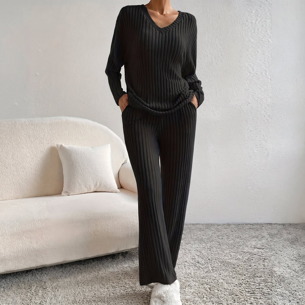 Front view showing v-neckline, long sleeves, side pockets and wide legs, black