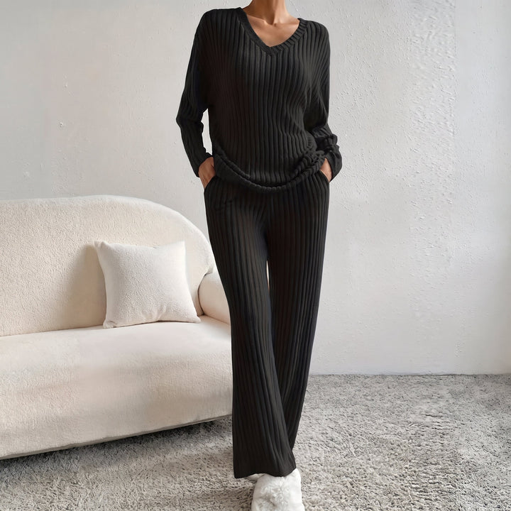 Front view showing v-neckline, long sleeves, side pockets and wide legs, black