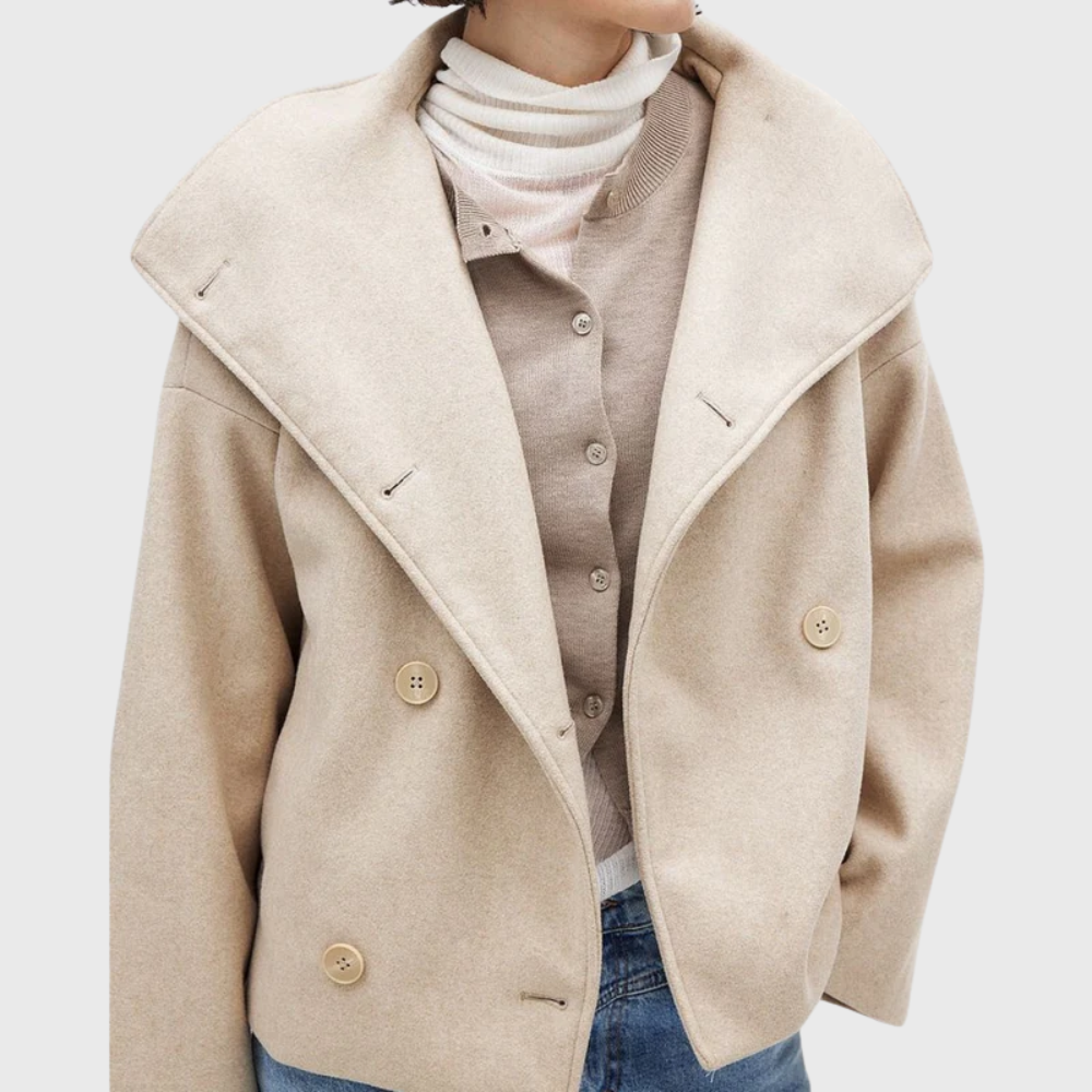 Front view showing collared neckline, wide lapels and double-breasted buttons, beige