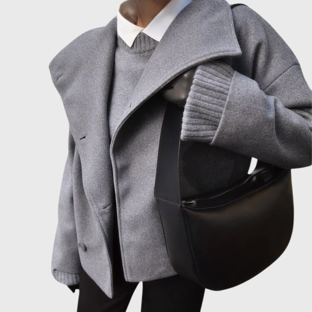 Side view showing wide lapels, long sleeves and side pocket, dark grey