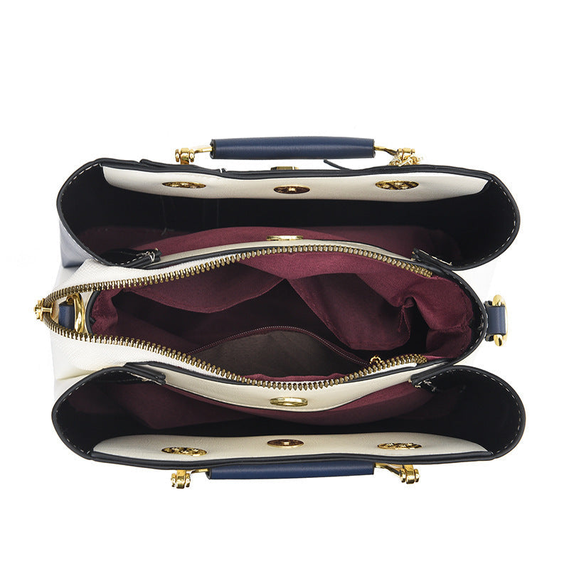 Detail view of open top showing three compartments and middle zip