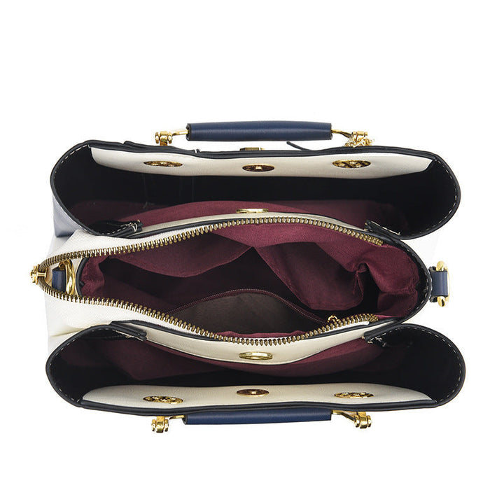 Detail view of open top showing three compartments and middle zip