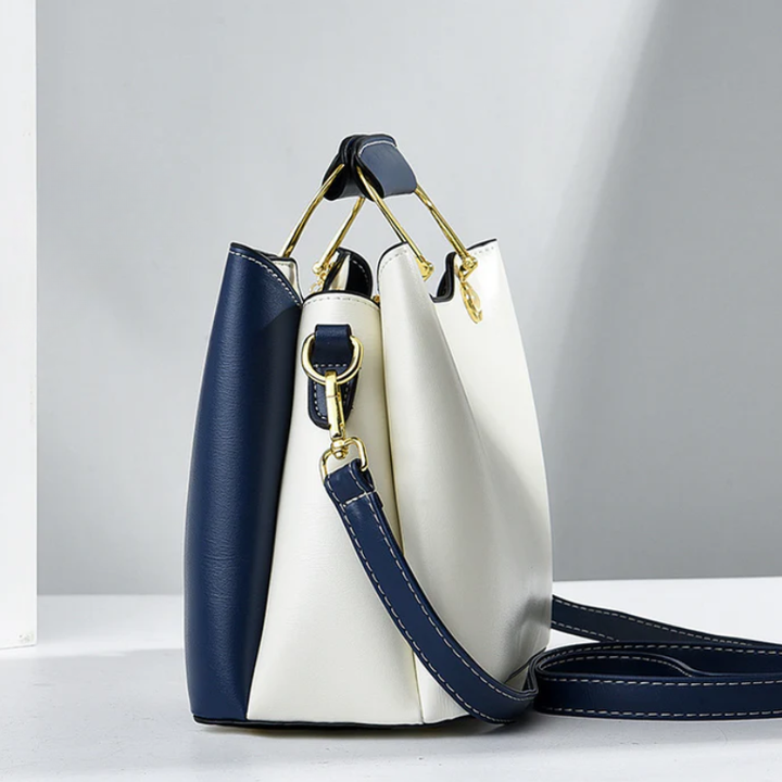 Side view showing side panel, top handle and crossbody strap