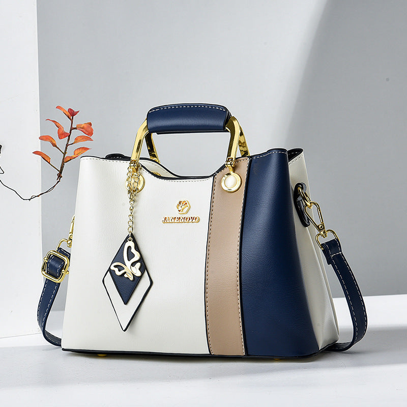 Front view showing top handle, butterfly charm and colour-block panels