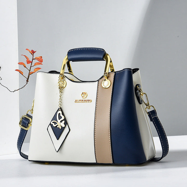 Front view showing top handle, butterfly charm and colour-block panels