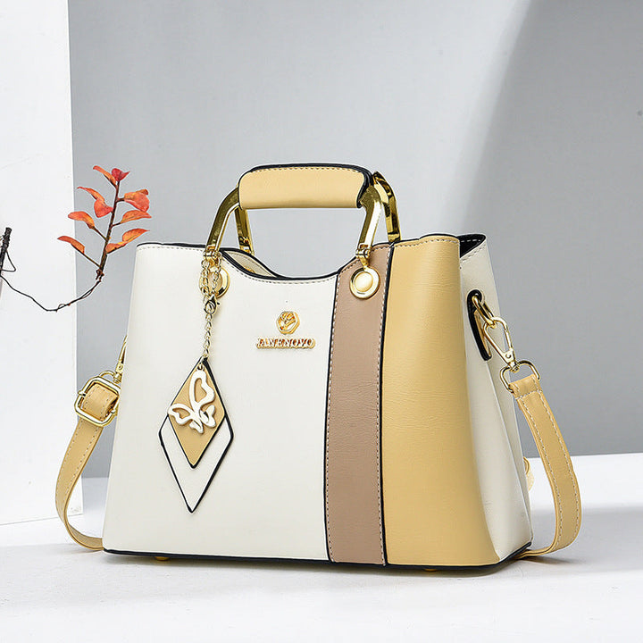 Front view showing top handle, butterfly charm and colour-block body
