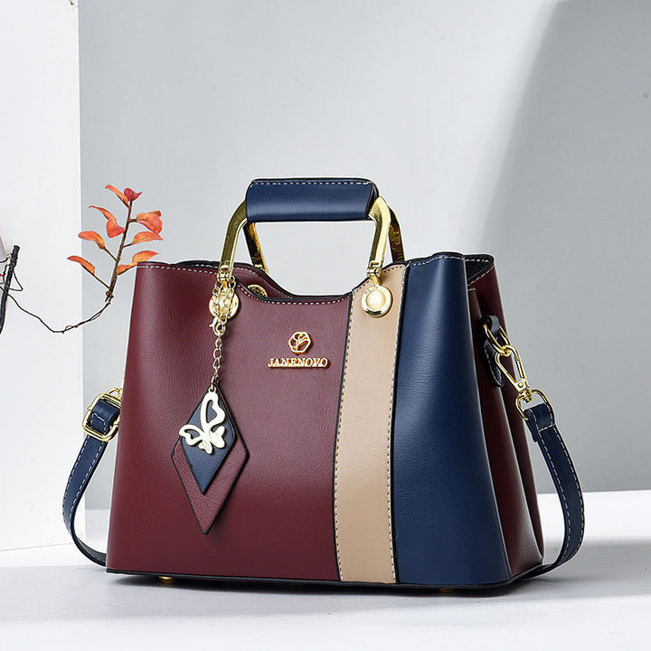 Front view showing top handle, butterfly charm and colour-block panels