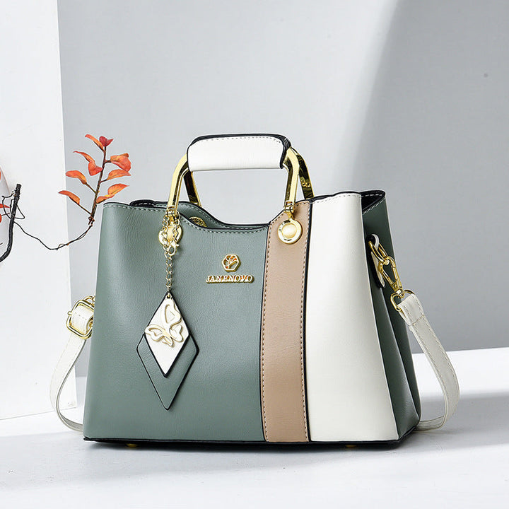Front view showing top handle, butterfly charm and colour-block panels