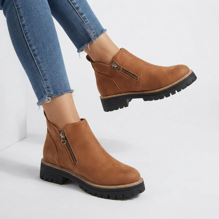 Side zip fastening close-up on the ankle boots