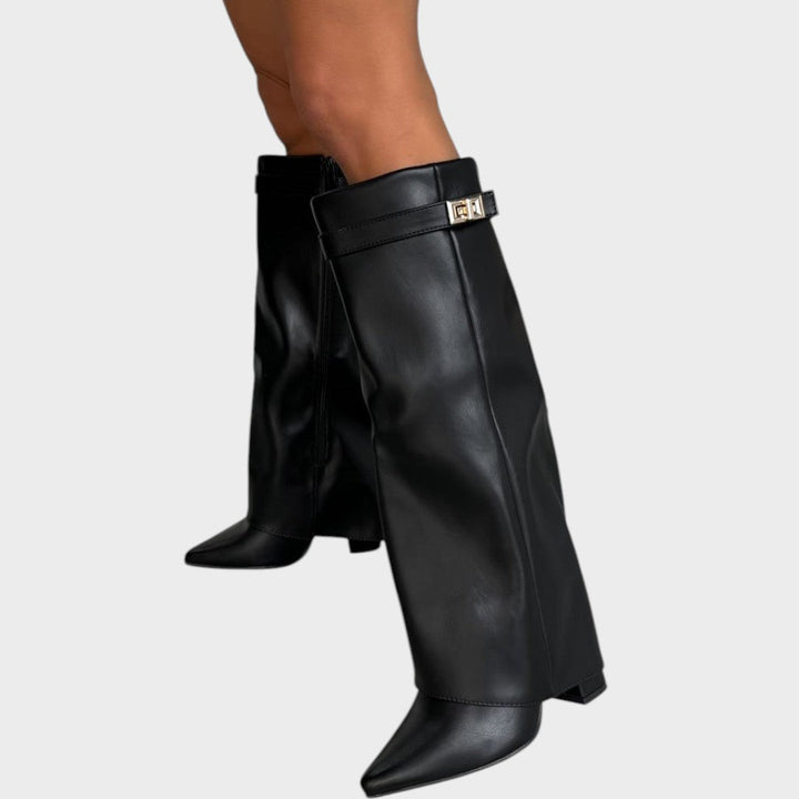 Side view of fold-over shaft boot with twist-lock strap and pointed toe, black
