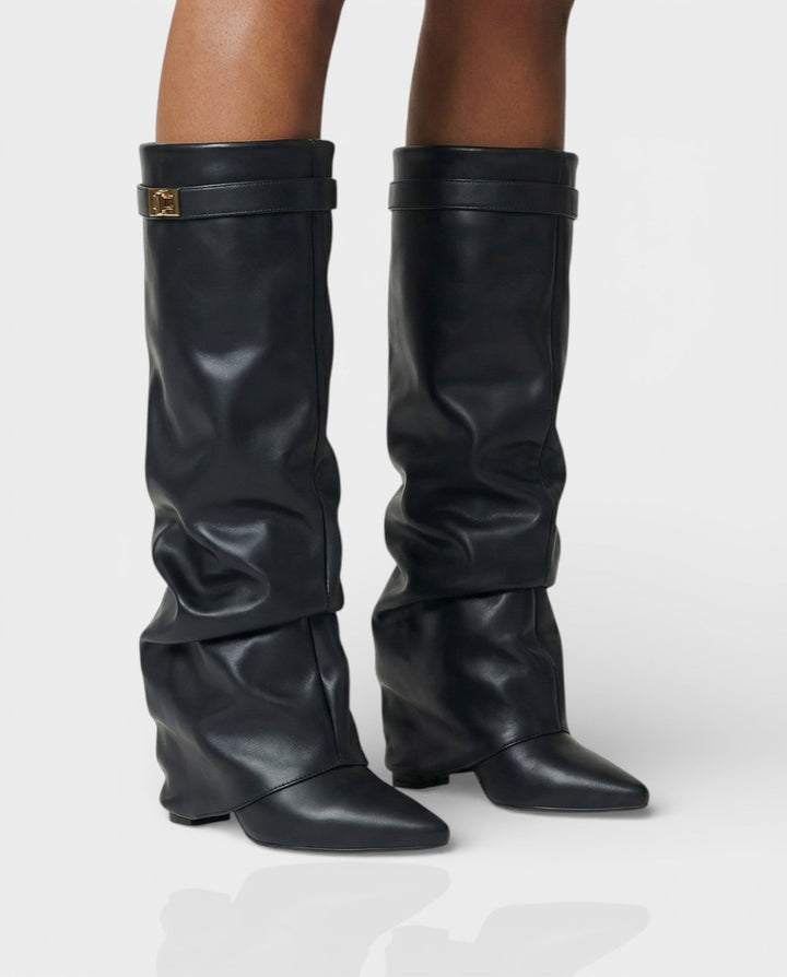 Front view of foldover shaft, turn-lock strap, pointed toe and block heel, black leather
