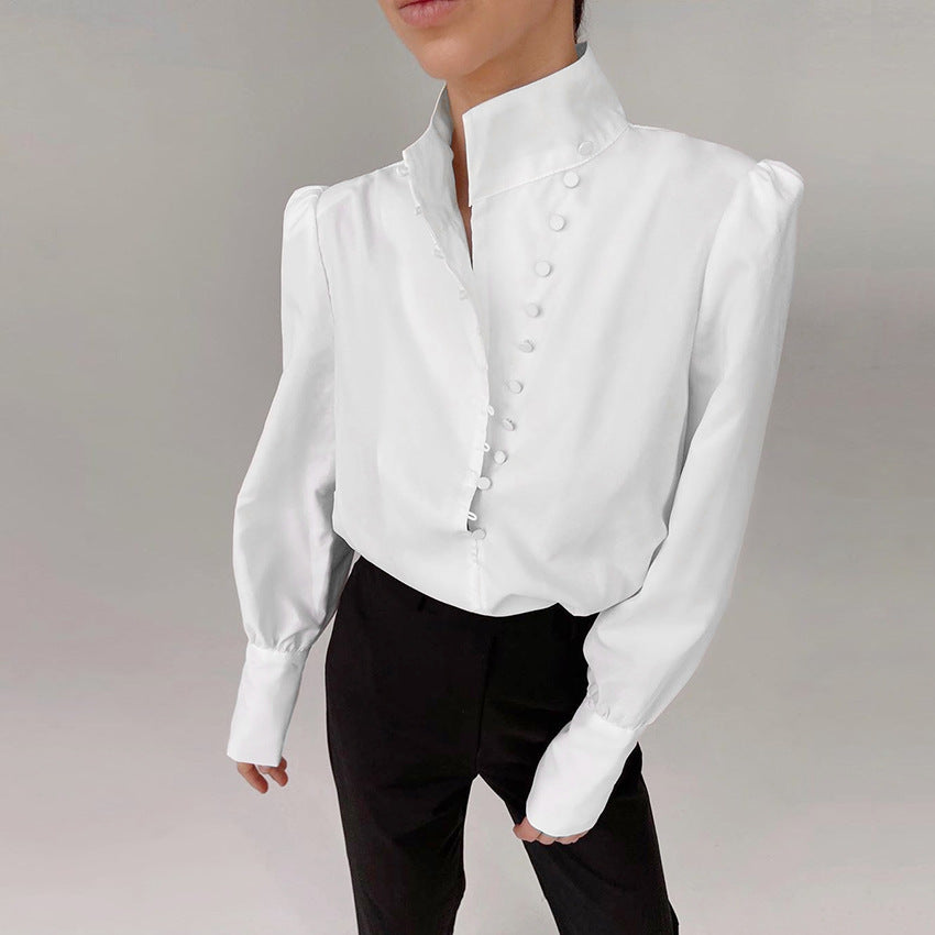 Front view showing stand collar, button placket with covered buttons and banded cuffs, white
