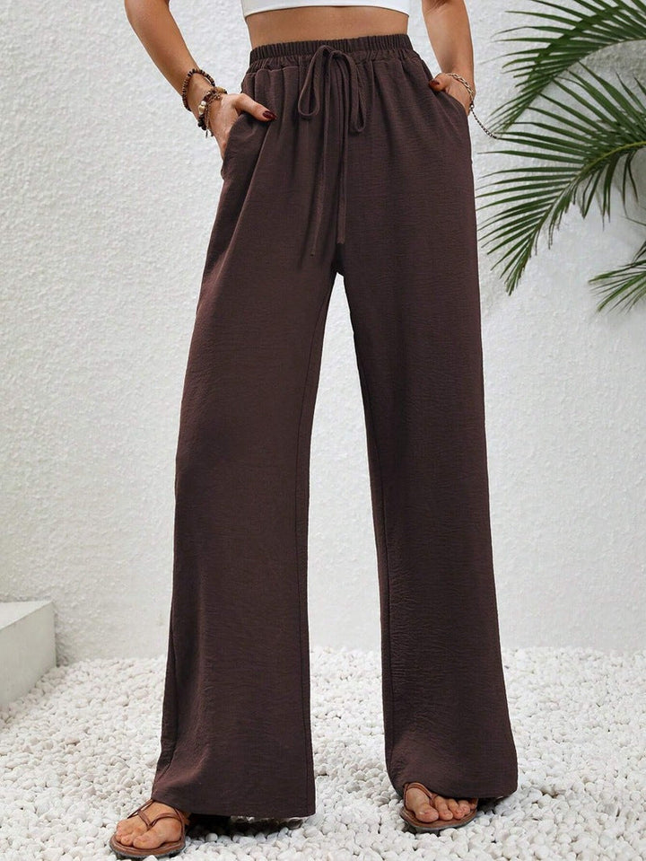 Front view of side pockets and wide legs, dark brown