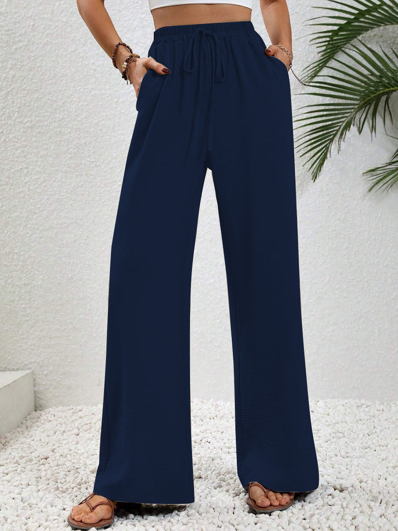 Front view of gathered banded waist with drawstring tie and wide legs, navy blue