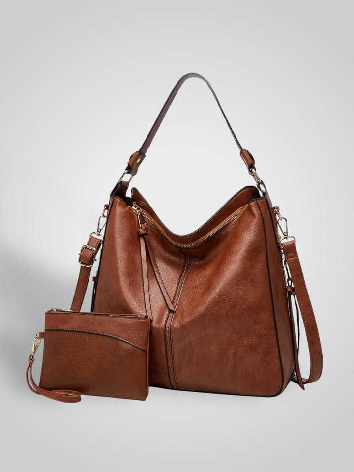 Front view showing top handle, crossbody strap, top zip closure and matching pouch, coffee