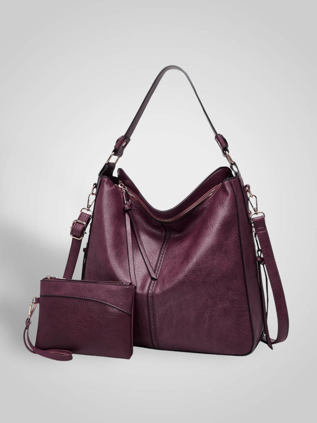 Front view showing top handle, crossbody strap, top zip closure and matching pouch, bordeaux