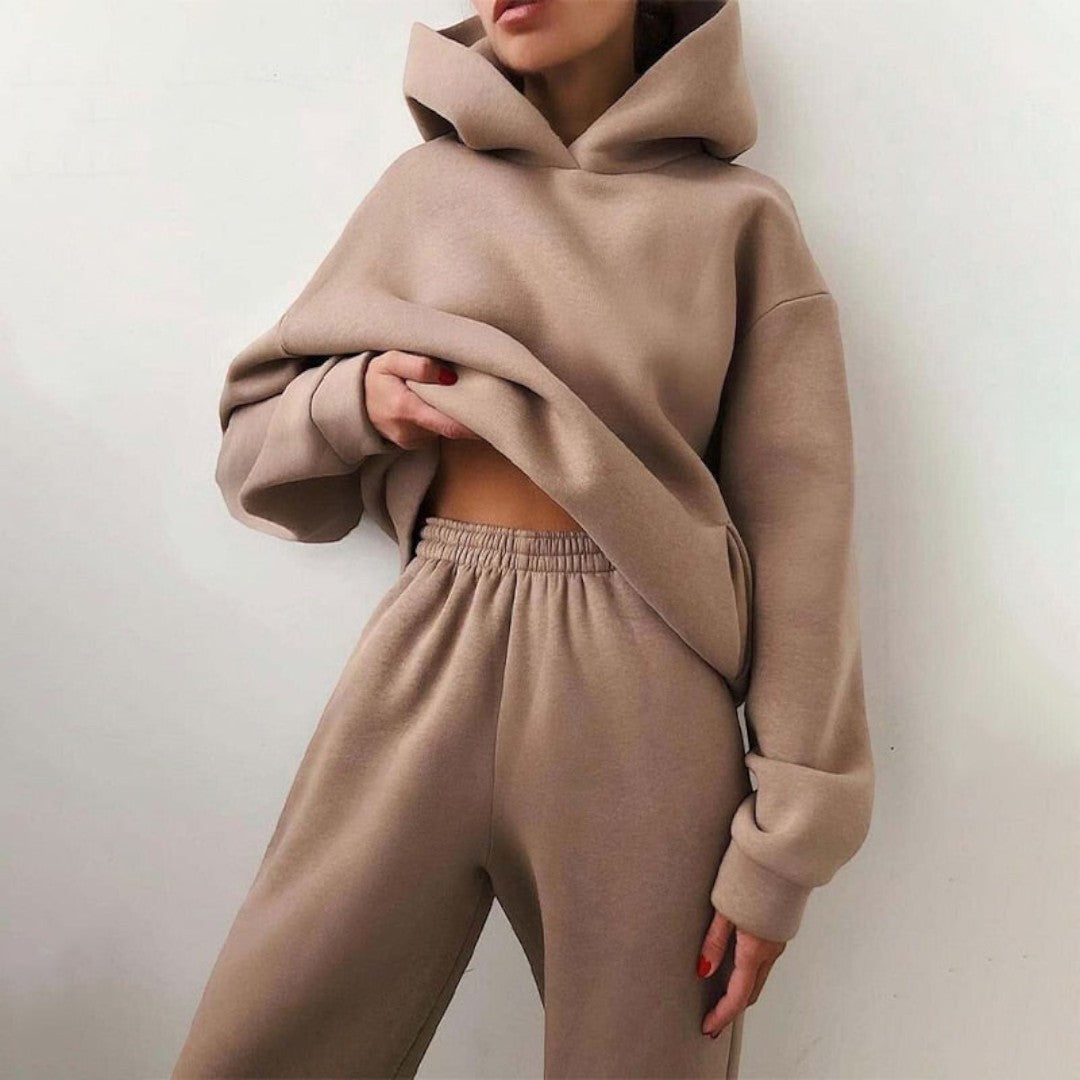 Side view showing hood, long sleeves, banded cuffs and banded waist of trousers