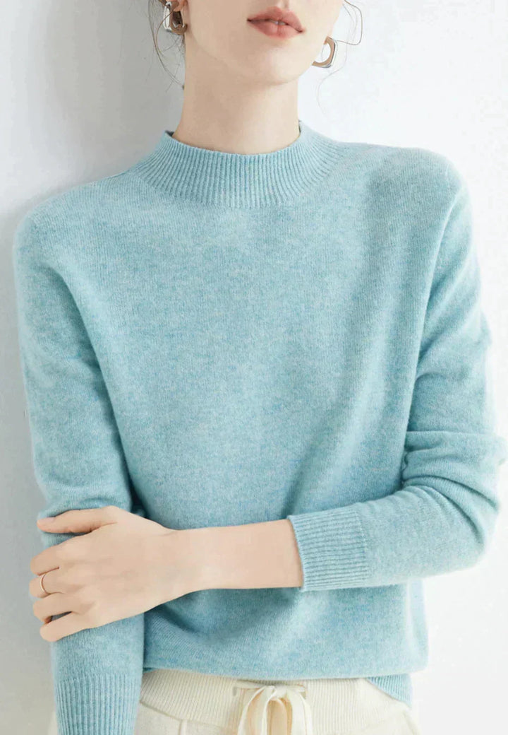 Front view showing mock neckline and long sleeves, light blue