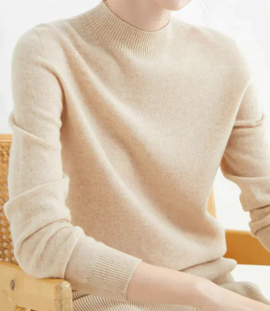 Side view showing mock neckline and ribbed cuffs, beige