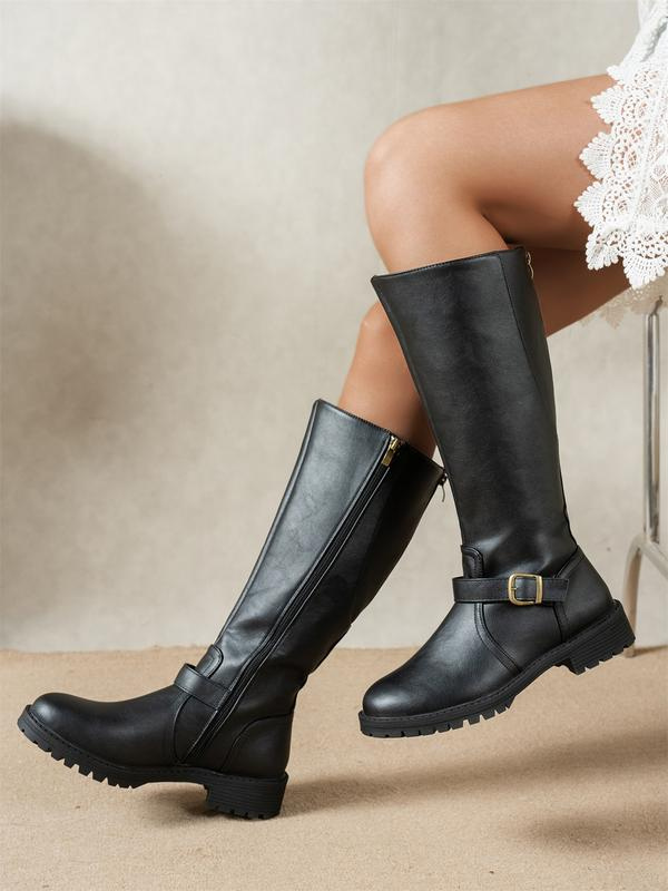 Side view of shaft upper with buckle strap, side zip and lug sole, black
