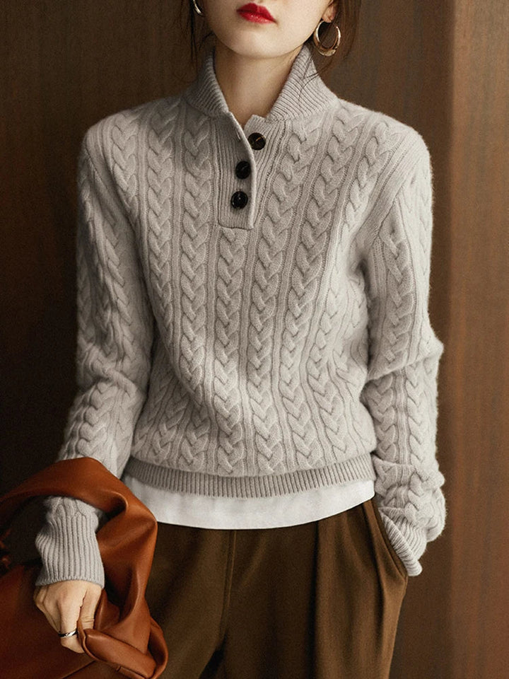 Front view showing stand collar and cable-knit bodice, grey