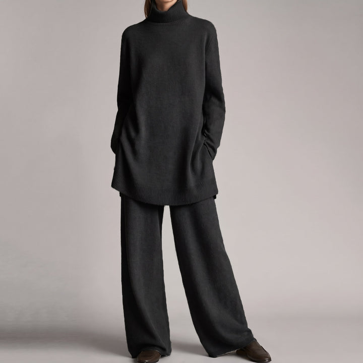 Front view showing turtleneck, long sleeves, side pockets and wide legs, black