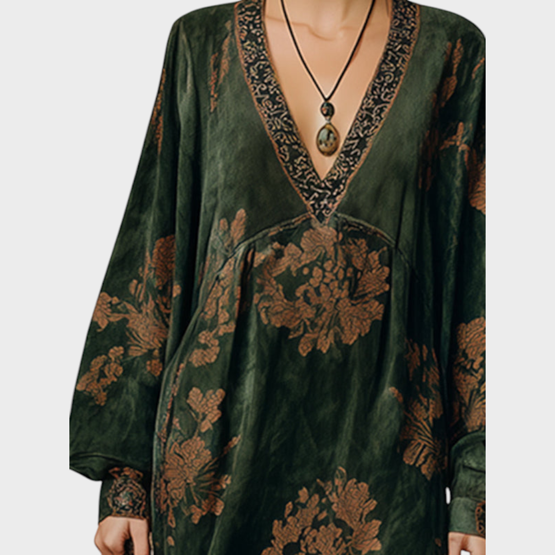 Detail view of deep v-neckline with stitched border and banded cuffs