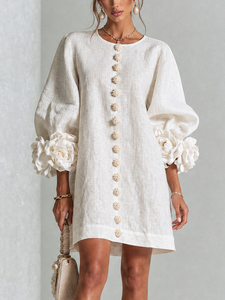 Front view of round neckline, button placket and rose-shaped cuffs, white
