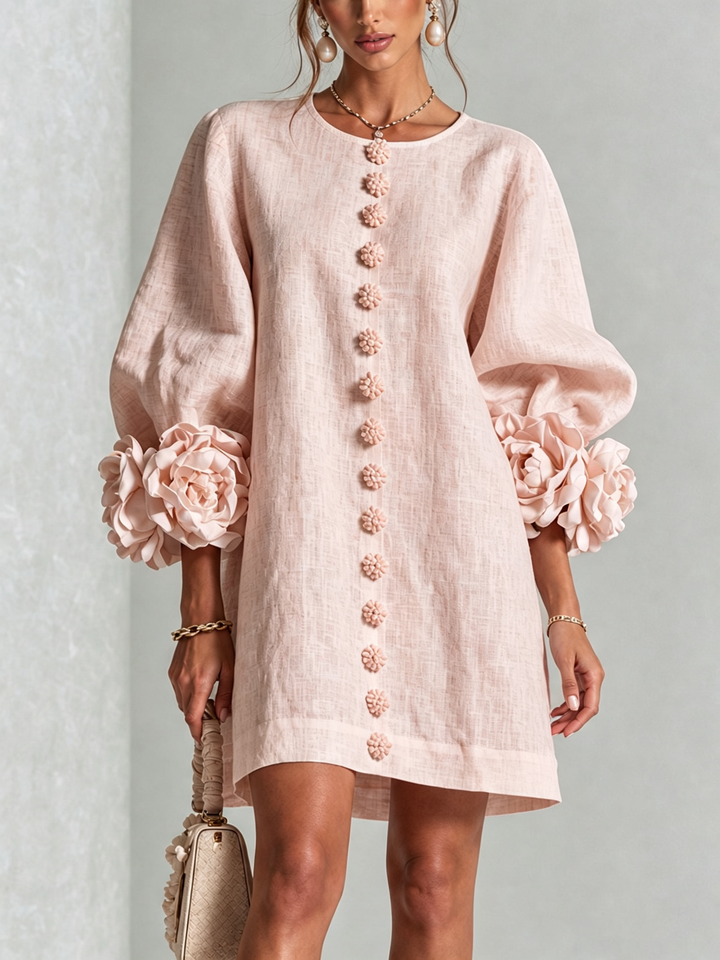 Front view of round neckline, button placket and rose-shaped cuffs, pink