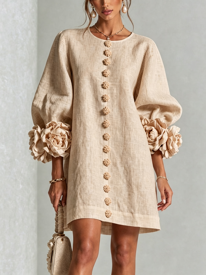 Front view of round neckline, button placket and rose-shaped cuffs, beige