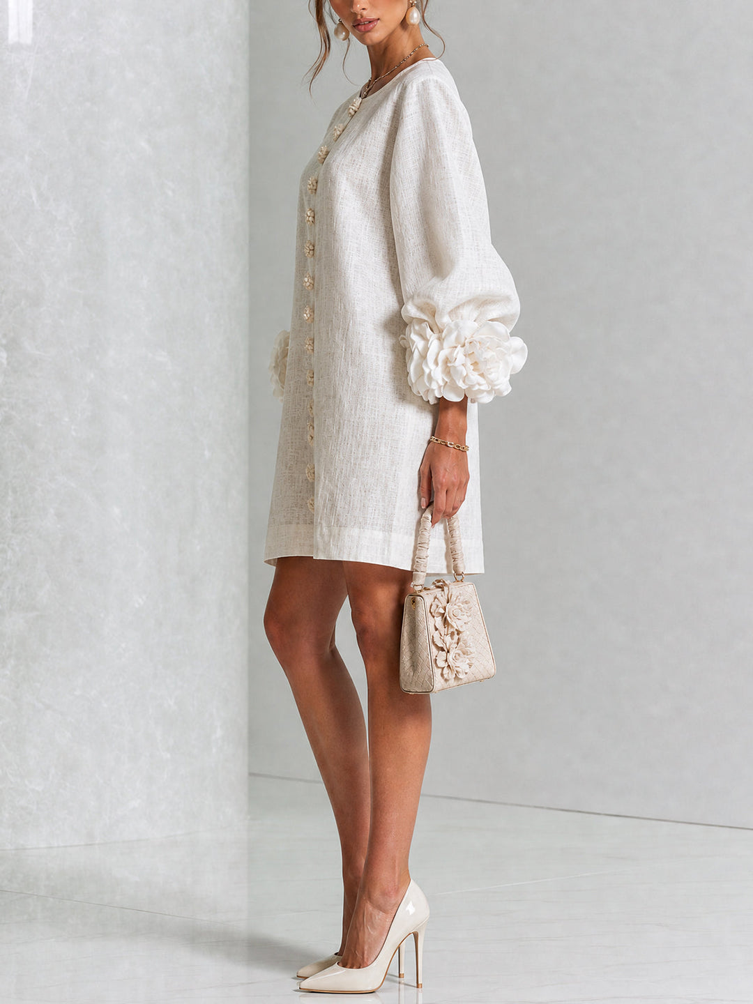 Side view of long sleeves, button placket and rose-shaped cuffs
