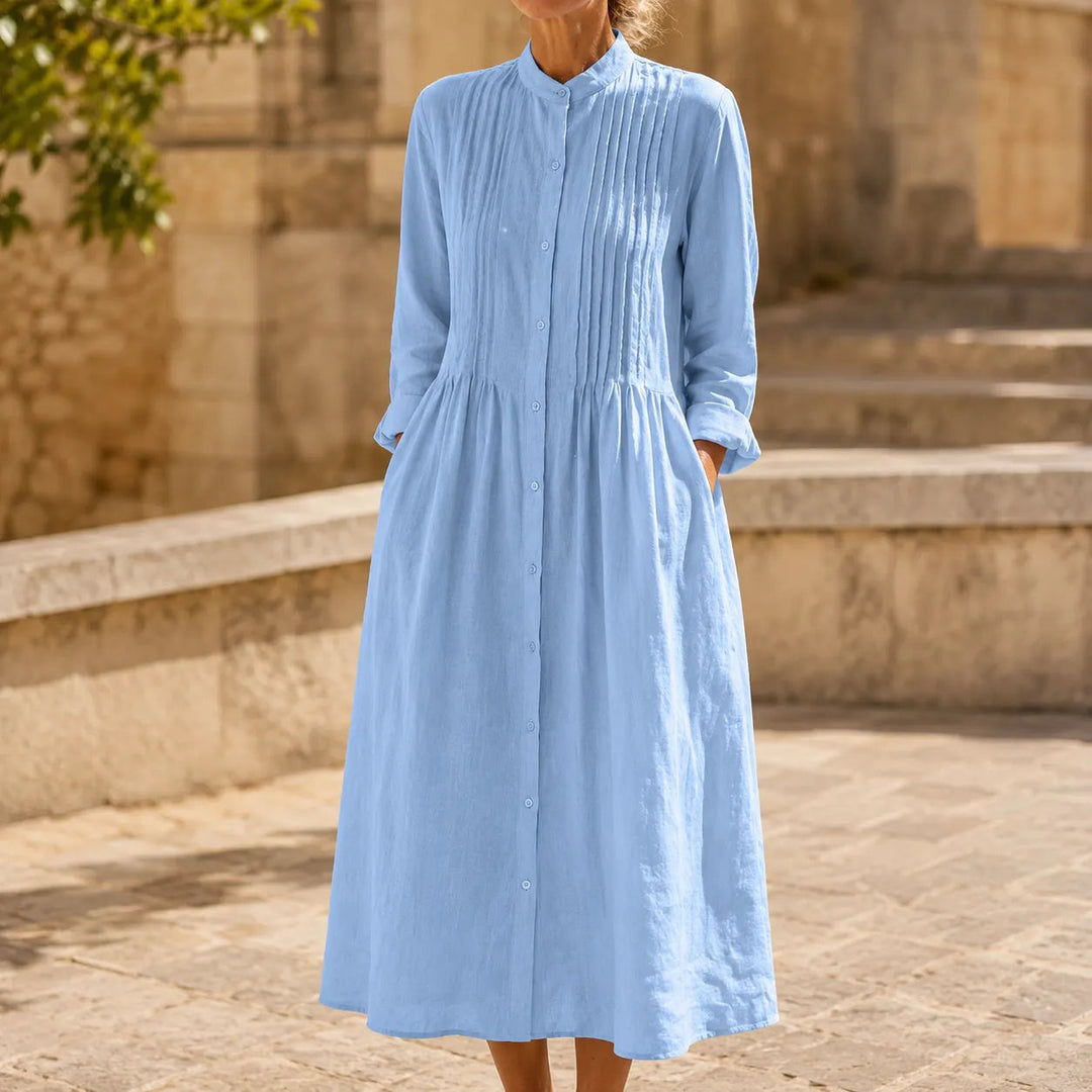 Front view showing stand collar, pintuck bodice, button placket and gathered skirt