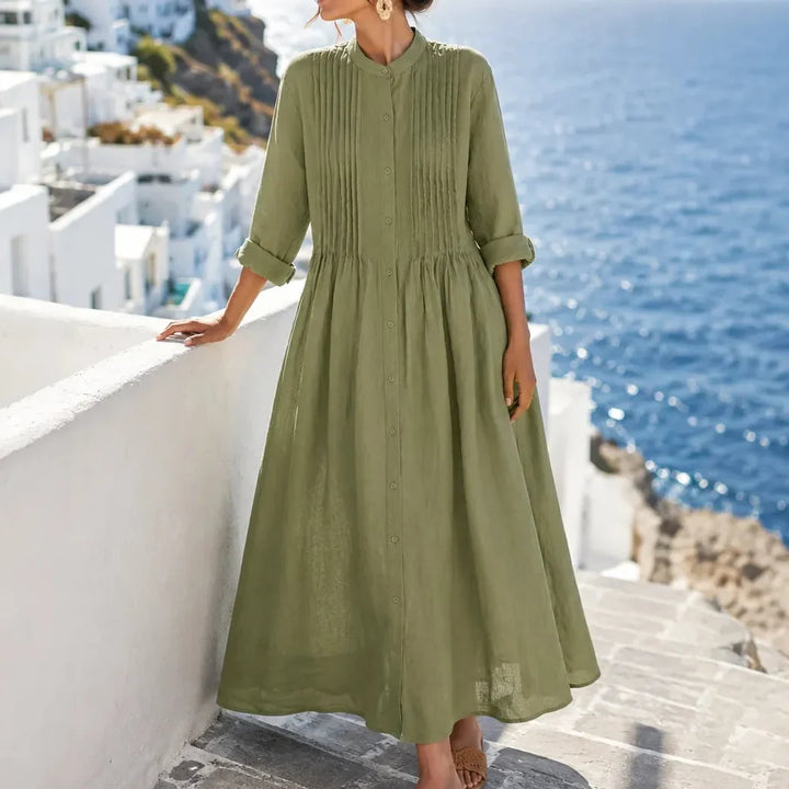 Front view showing pintuck bodice, button front and gathered skirt, green