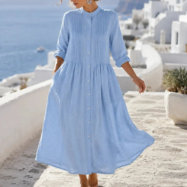 Front view showing pintuck bodice, side pockets and gathered skirt, blue