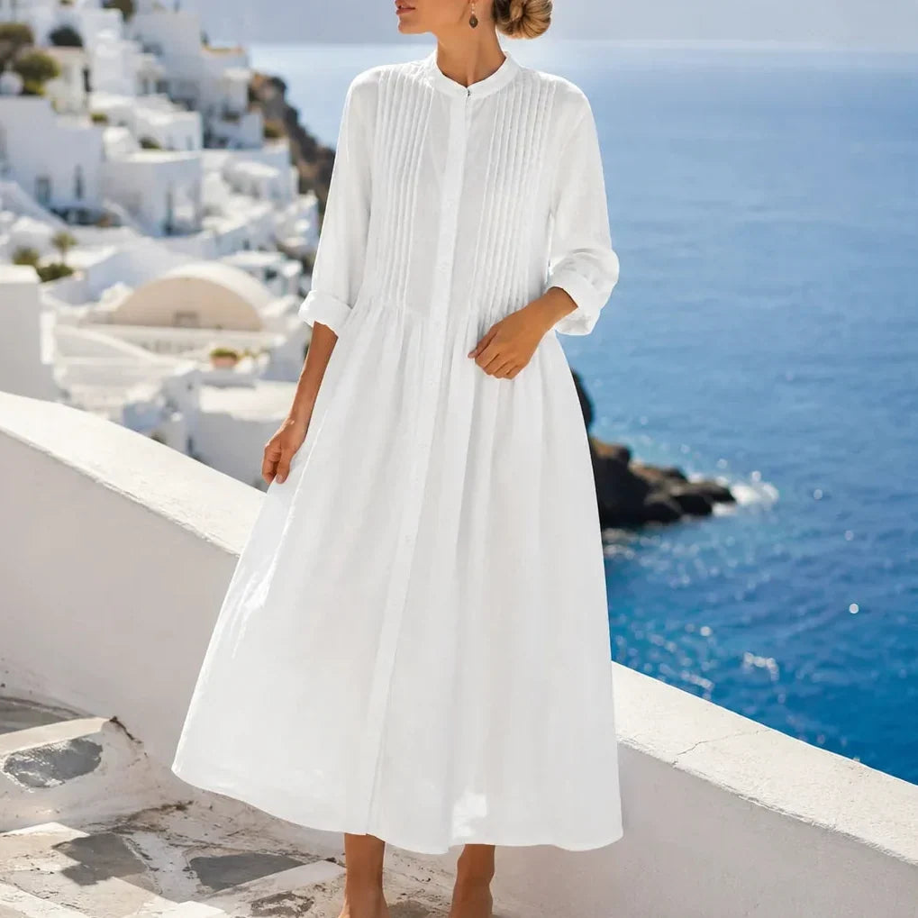 Side view showing stand collar, pintuck bodice and gathered skirt, white