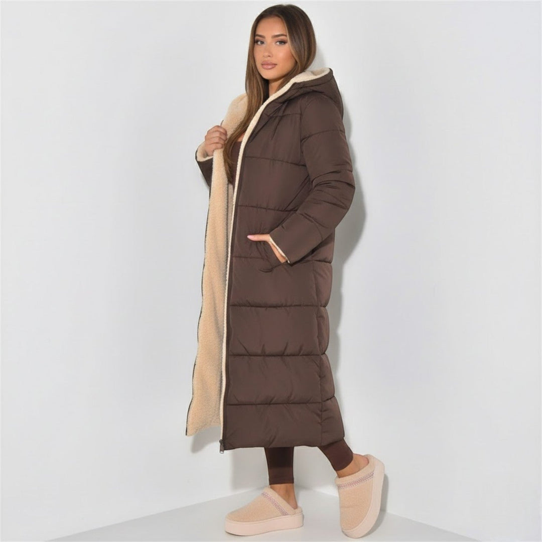 Side view showing hood, quilted body and ankle-length hem
